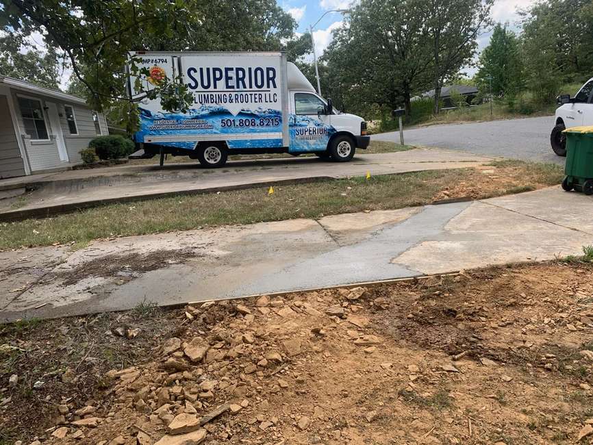 The Superior Plumbing & Rooter LLC company truck sitting in the driveway of a customer's house.